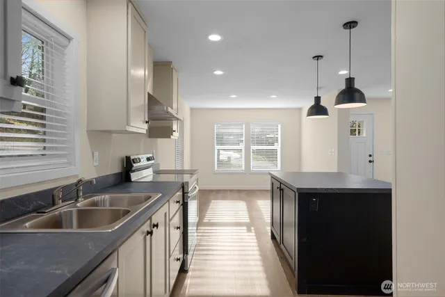 a kitchen with a sink stove and cabinets