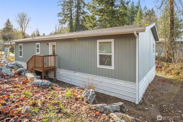 a view of backyard with a tub and wooden fence