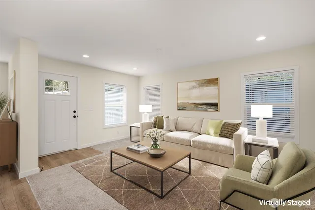 a living room with furniture a rug and a window
