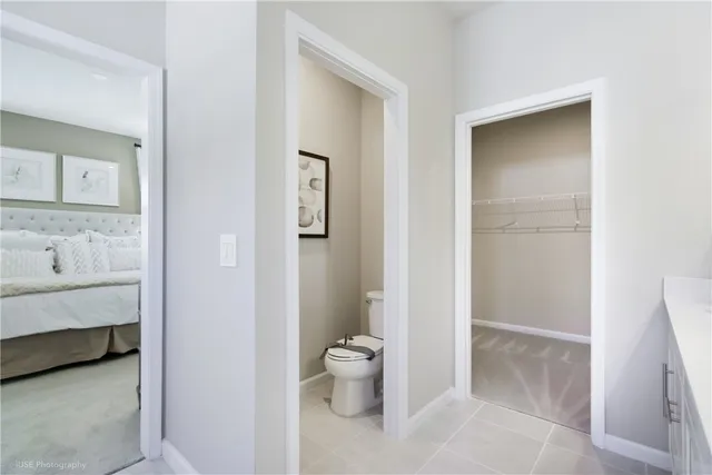 a bathroom with a toilet sink and a mirror