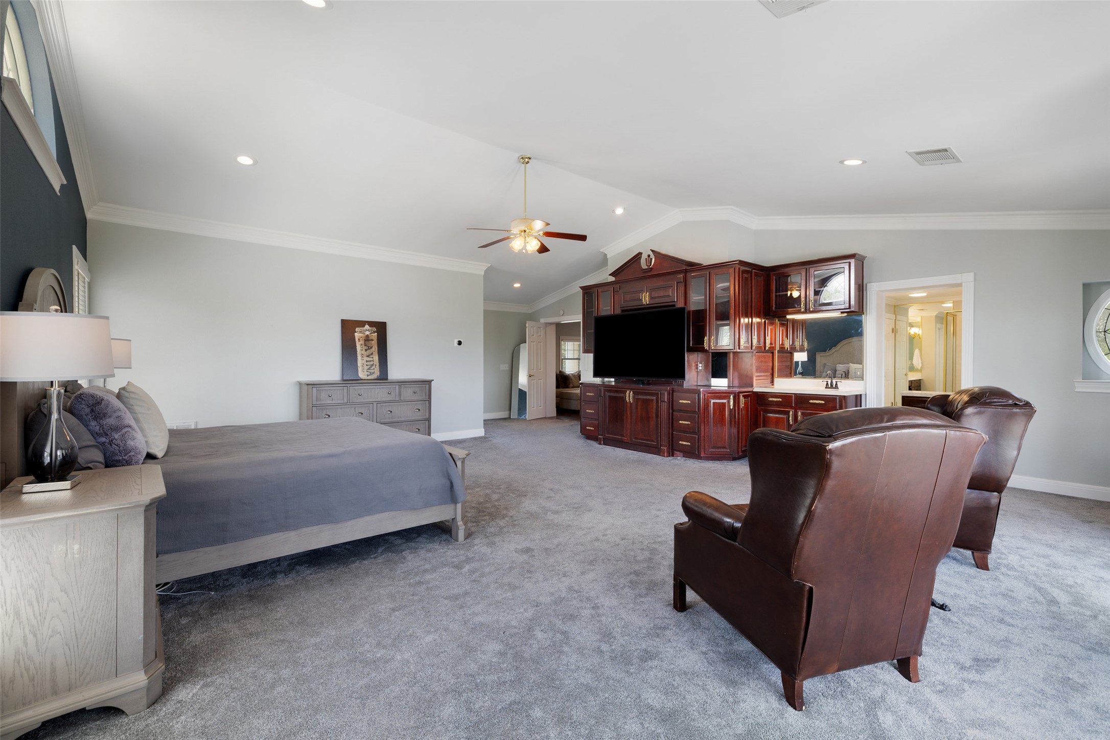 17700 North Rim Drive Leander, TX 78641 - Photo 29 of 38 Bedroom featuring light colored carpet, baseboards, lofted ceiling, ornamental molding, and recessed lighting