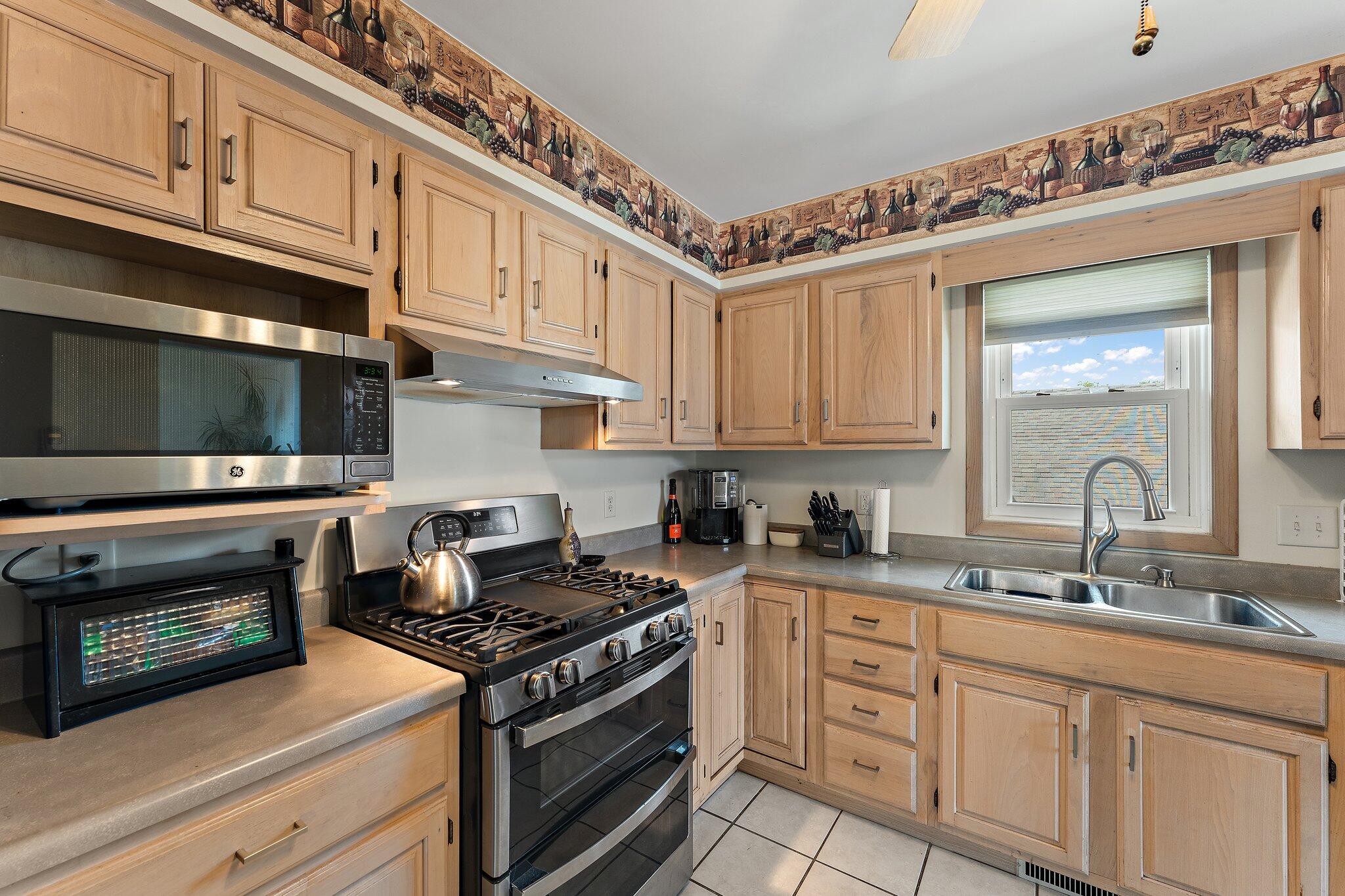 658 Forest Avenue Griffith, IN 46319 - Photo 12 of 31 a kitchen with stainless steel appliances granite countertop a stove and a microwave