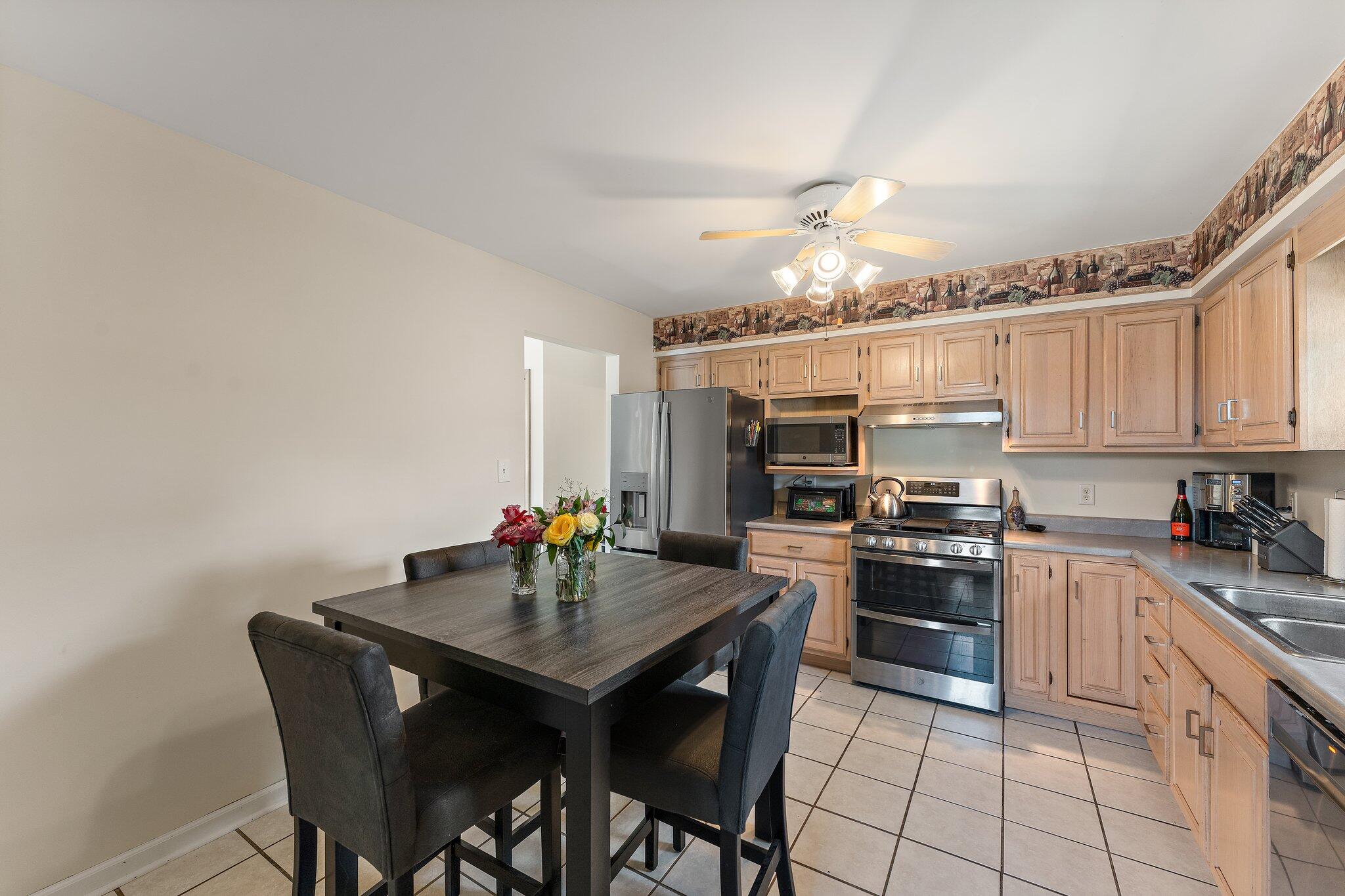 658 Forest Avenue Griffith, IN 46319 - Photo 13 of 31 a kitchen with stainless steel appliances kitchen island granite countertop a sink and cabinets