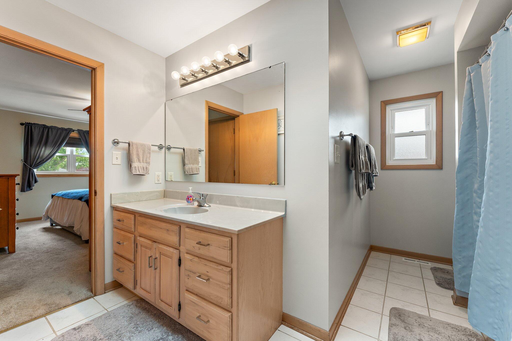 658 Forest Avenue Griffith, IN 46319 - Photo 16 of 31 a spacious bathroom with a double vanity sink and a mirror