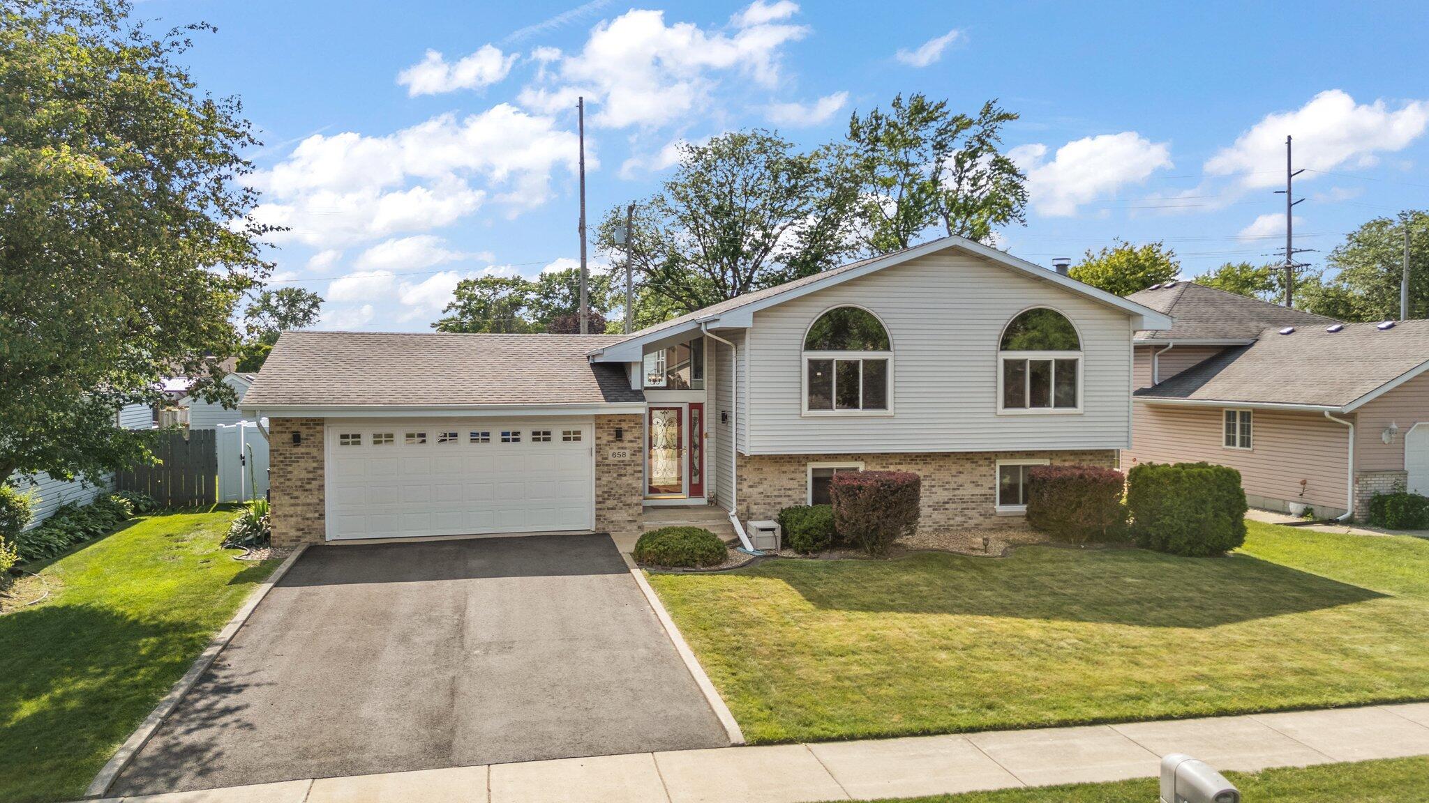 658 Forest Avenue Griffith, IN 46319 - Photo 2 of 31 a front view of a house with a yard and garage