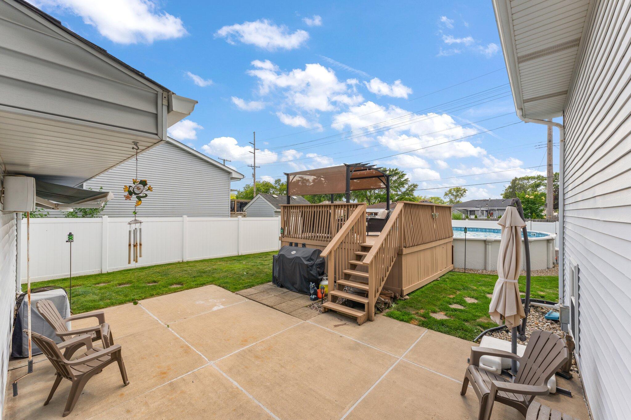 658 Forest Avenue Griffith, IN 46319 - Photo 25 of 31 a view of a patio with table and chairs with wooden fence