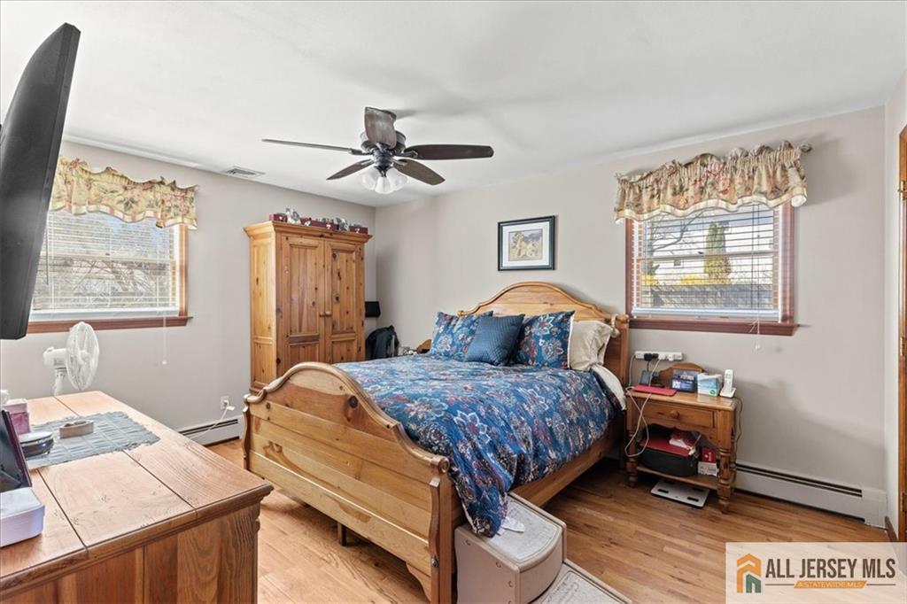 20 Running Brook Road Ewing, NJ 08638 - Photo 12 of 23 a bedroom with a bed and a chandelier