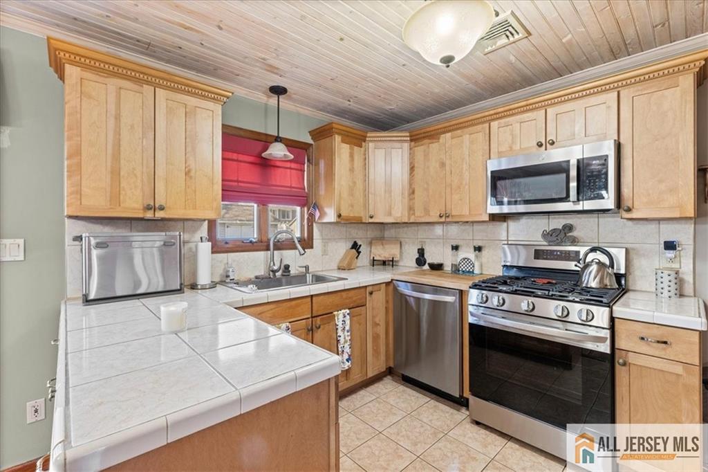 20 Running Brook Road Ewing, NJ 08638 - Photo 17 of 23 a kitchen with stainless steel appliances granite countertop a stove sink microwave and cabinets