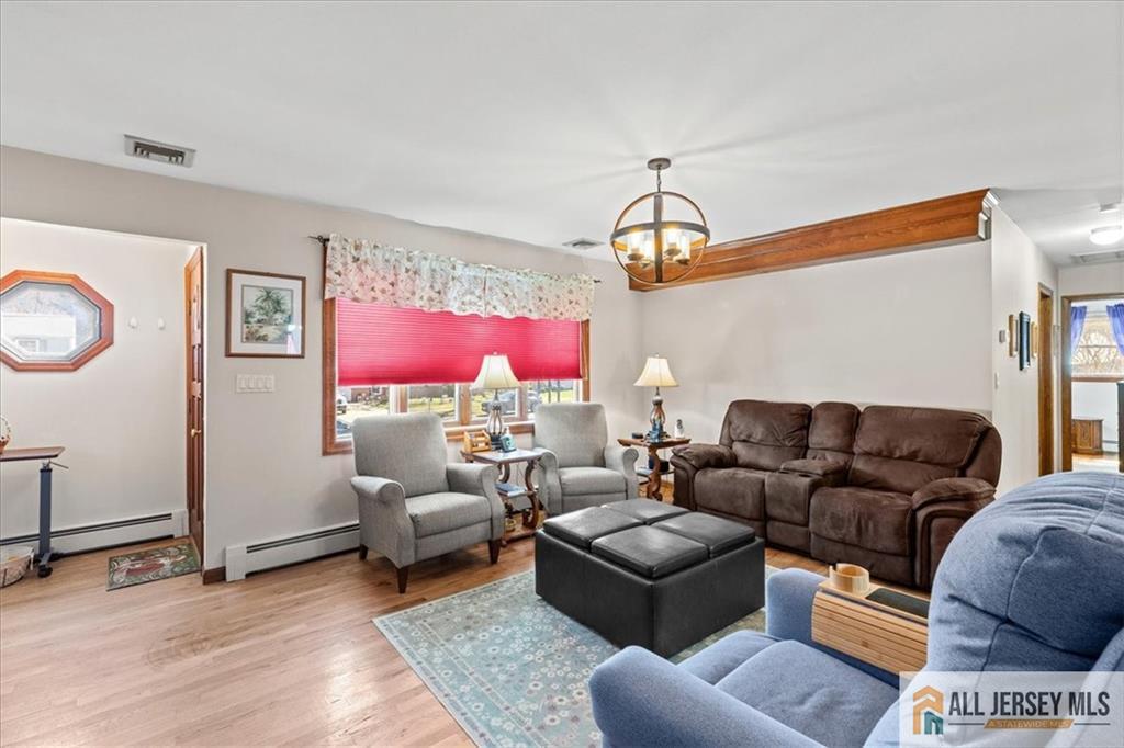 20 Running Brook Road Ewing, NJ 08638 - Photo 5 of 23 a living room with furniture a chandelier and a window