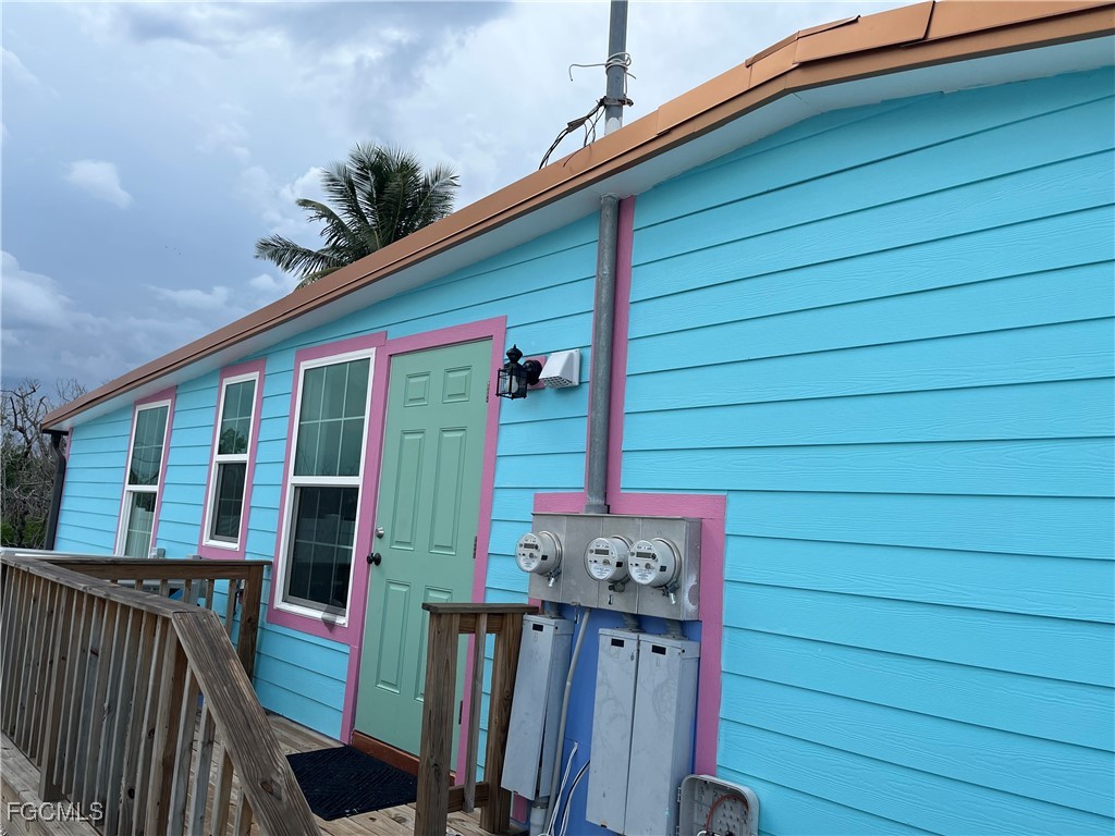 4874 Pine Island Road, Unit A St. James City, FL 33956 - Photo 1 of 19 a view of a house with wooden fence