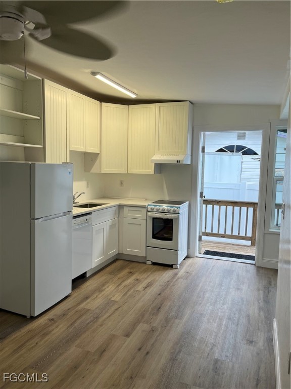 4874 Pine Island Road, Unit A St. James City, FL 33956 - Photo 7 of 19 a kitchen with stainless steel appliances a stove top oven a sink and a refrigerator