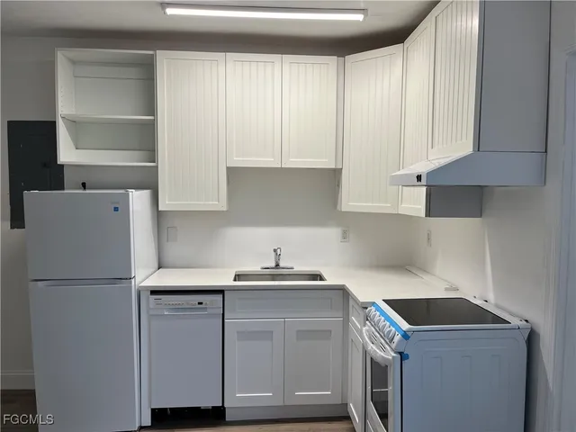 a kitchen with a sink cabinets and a refrigerator