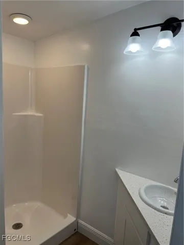a bathroom with a shower a toilet and sink