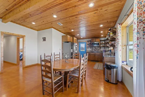 a spacious bedroom with a large bed and a chandelier