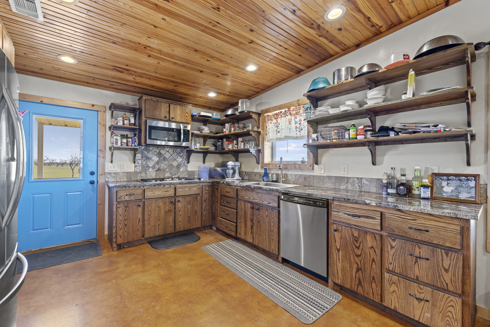 723 Fm 2926 Baird, TX 79504 - Photo 16 of 26 a kitchen with stainless steel appliances granite countertop a sink and cabinets