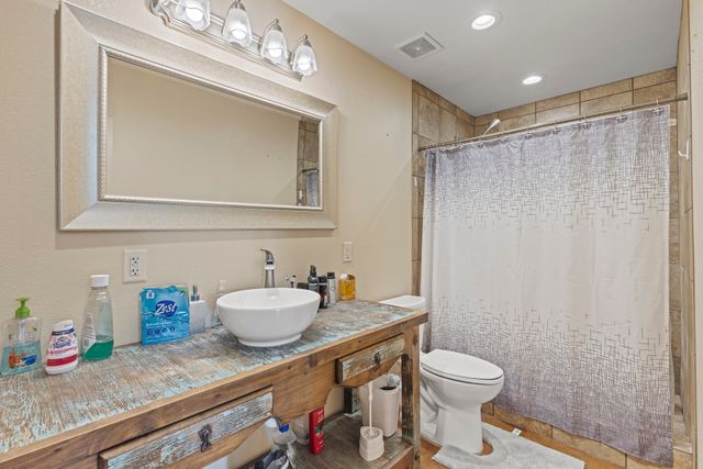 a bathroom with a sink toilet and shower