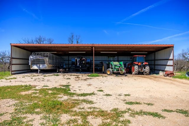 a living room with furniture kitchen view and a large window