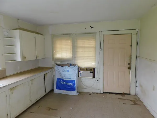 a spacious bedroom with a bed and a window