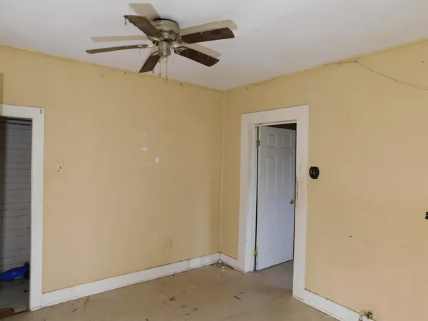 a view of a hallway with a ceiling fan and a chandelier fan