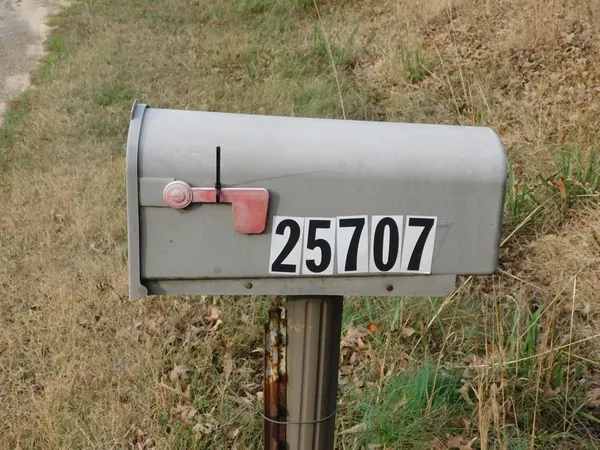 a view of a sign board with wooden fence