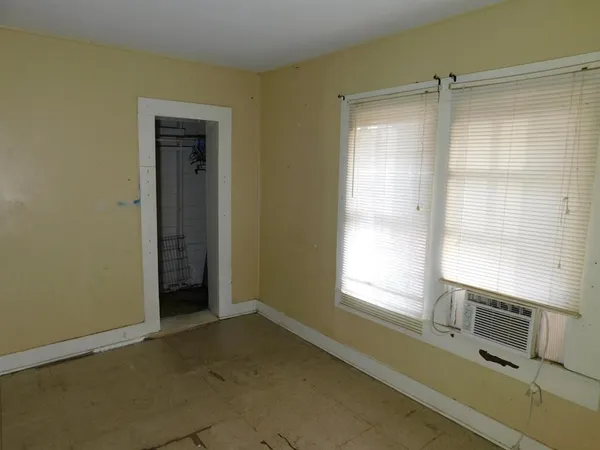 a room with a window and a ceiling fan