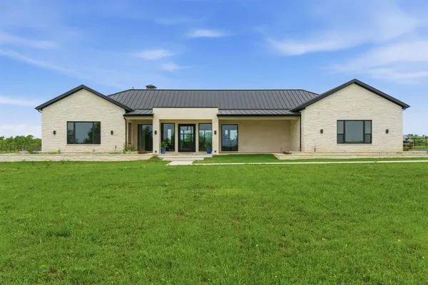 a front view of house with yard and green space
