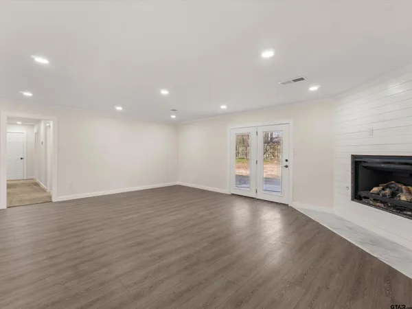 a view of kitchen with wooden floor and electronic appliances