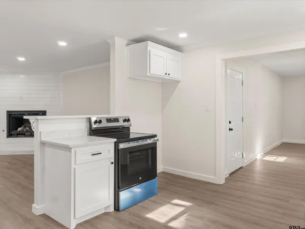 a kitchen with stainless steel appliances a sink stove and cabinets