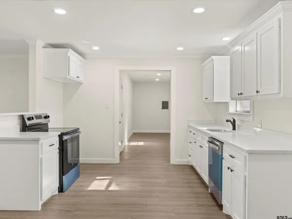 a kitchen with granite countertop a sink and a stove top oven