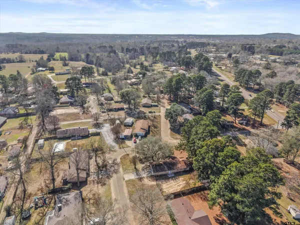 an aerial view of a house with outdoor space