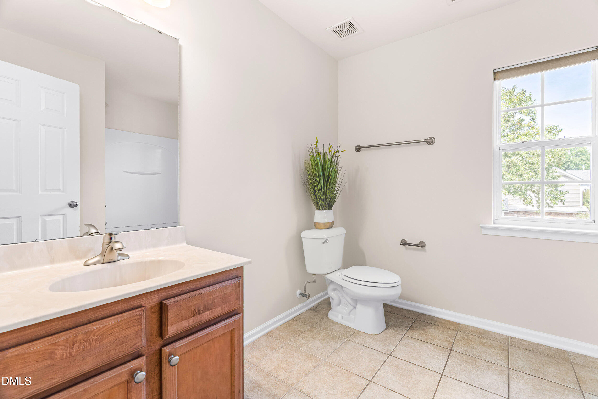 113 Cupp Court Raleigh, NC 27603 - Photo 20 of 29 a bathroom with a sink toilet and a window