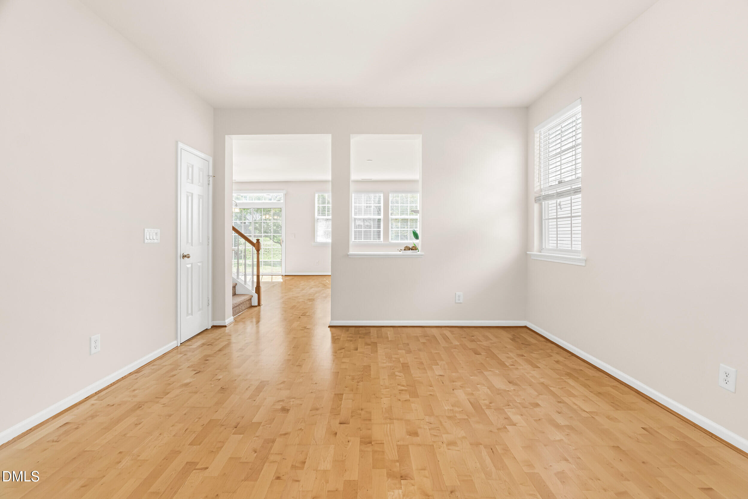 113 Cupp Court Raleigh, NC 27603 - Photo 4 of 29 an empty room with wooden floor and windows