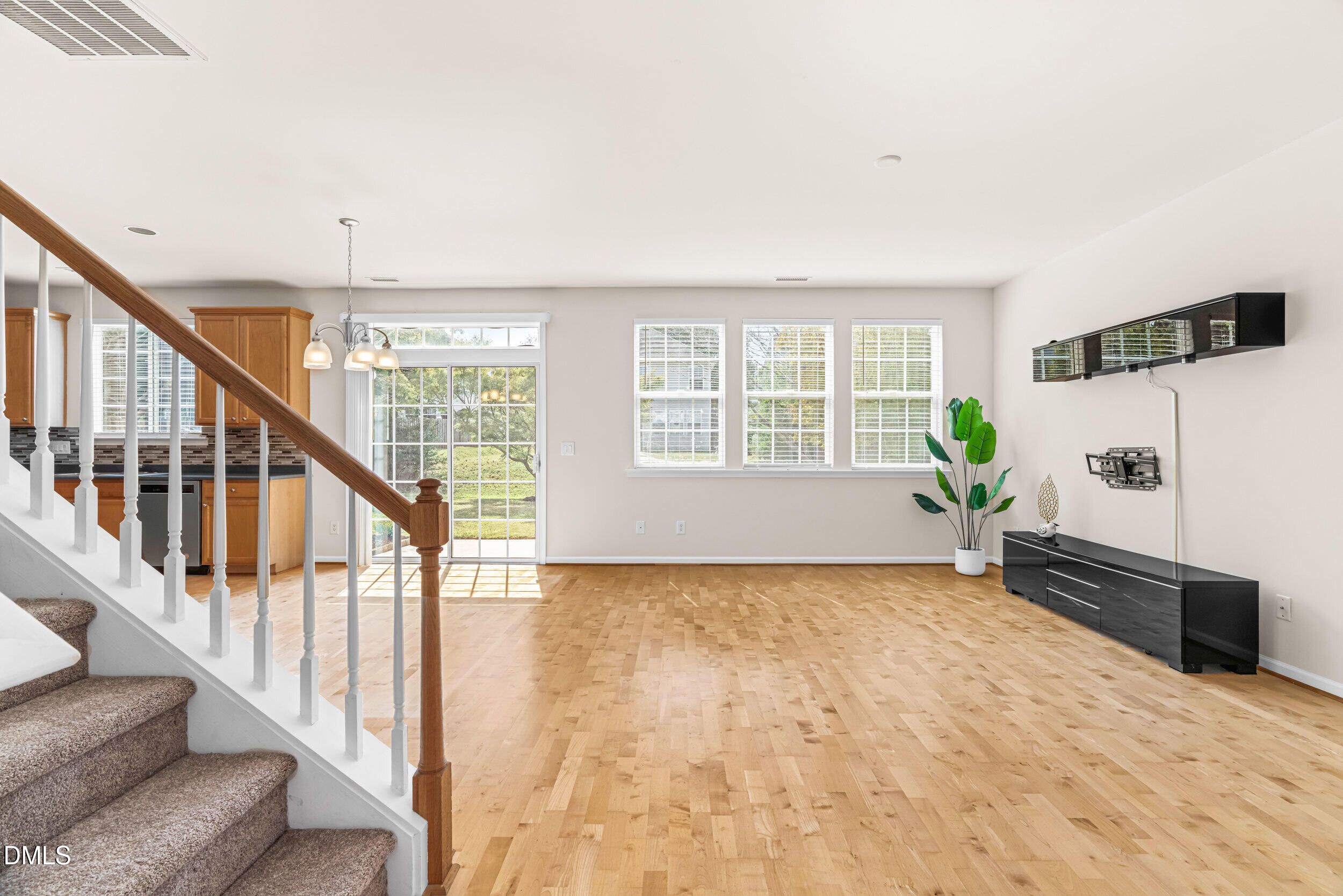 113 Cupp Court Raleigh, NC 27603 - Photo 6 of 29 a view of an empty room with wooden floor and a window