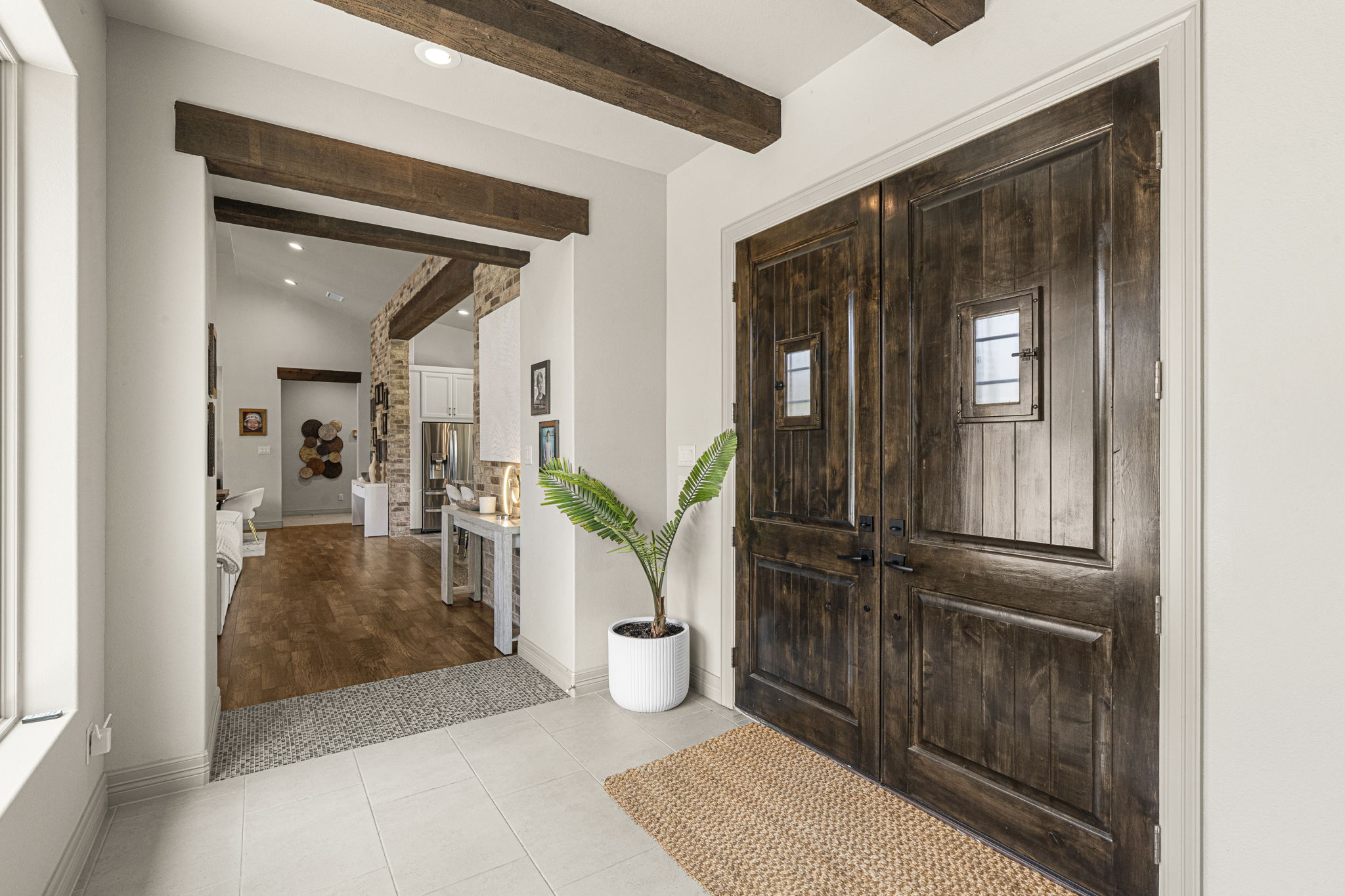 16202 Remuda Trail Buda, TX 78610 - Photo 4 of 40 Entryway featuring double doors with window accents, light tile flooring, and exposed ceiling beams