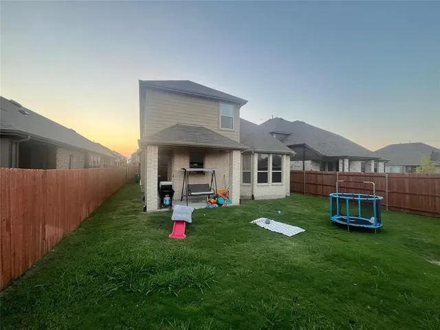 a view of a house with backyard porch and sitting area