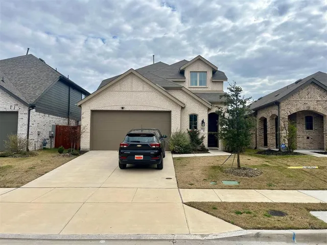 a car parked in front of white house