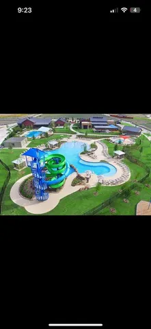 a view of a swimming pool with a yard