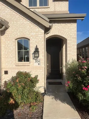 a front view of a house with plants