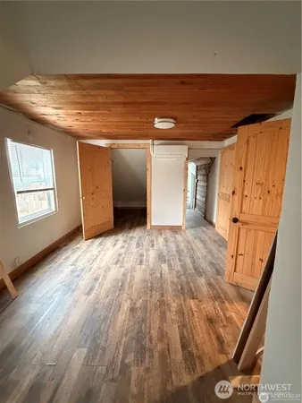 a view of an empty room and wooden floor