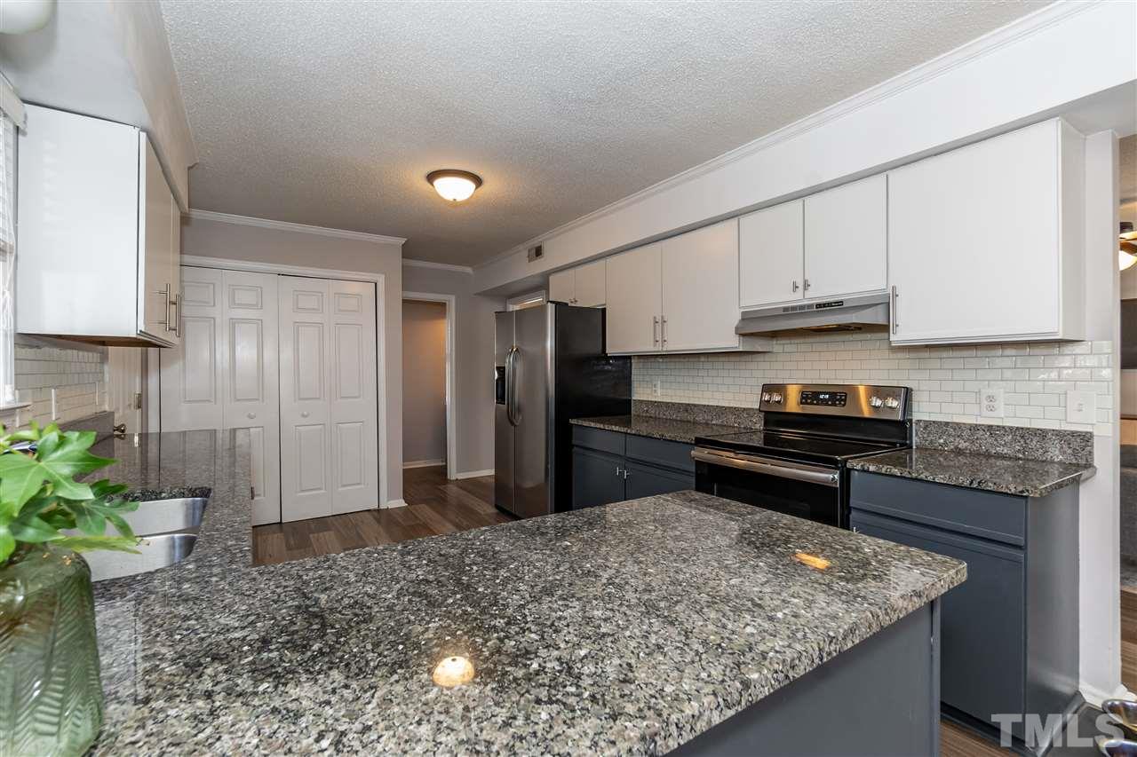 3628 Wickersham Way Raleigh, NC 27604 - Photo 6 of 21 a kitchen with stainless steel appliances granite countertop a sink stove and refrigerator