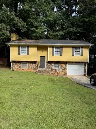 a front view of a house with a yard table and chairs