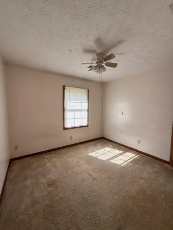 an empty room with a empty space and windows