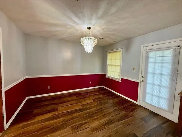a view of room with window and wooden floor