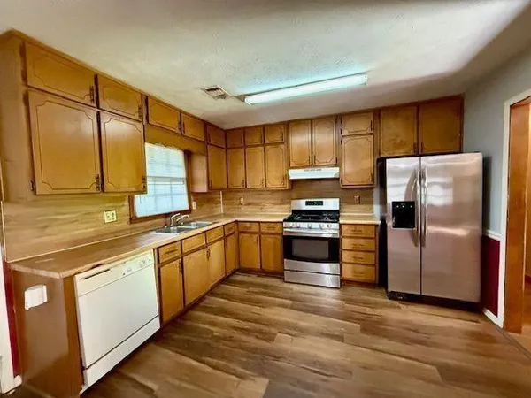 a kitchen with a refrigerator and a sink
