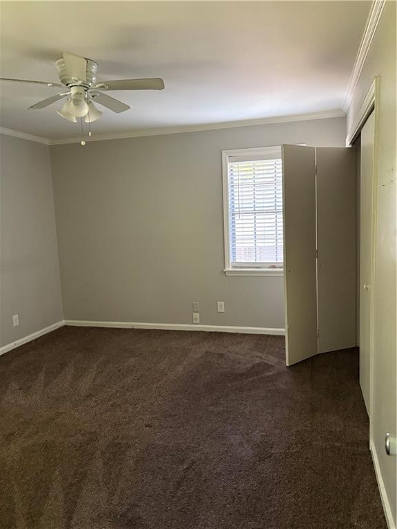 3211 Flamingo Drive East Point, GA 30344 - Photo 15 of 26 an empty room with a chandelier fan and windows