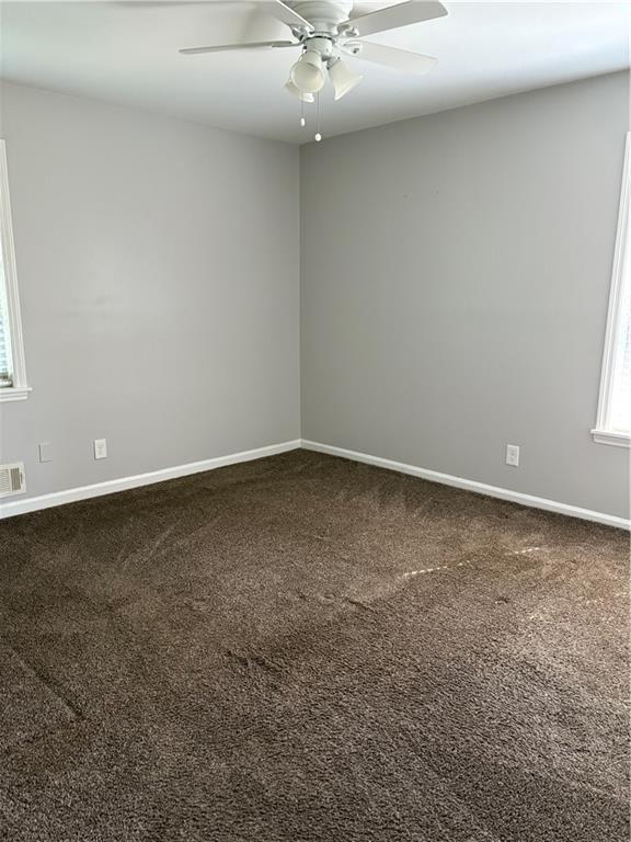 3211 Flamingo Drive East Point, GA 30344 - Photo 16 of 26 an empty room with a ceiling fan and carpet