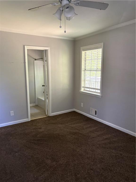 3211 Flamingo Drive East Point, GA 30344 - Photo 17 of 26 an empty room with a chandelier fan and windows