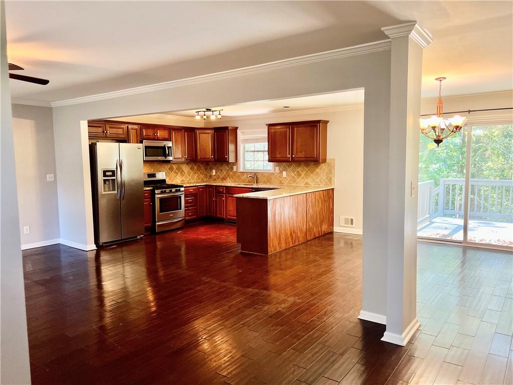 3211 Flamingo Drive East Point, GA 30344 - Photo 5 of 26 a view of kitchen with stainless steel appliances wooden floor and living room view