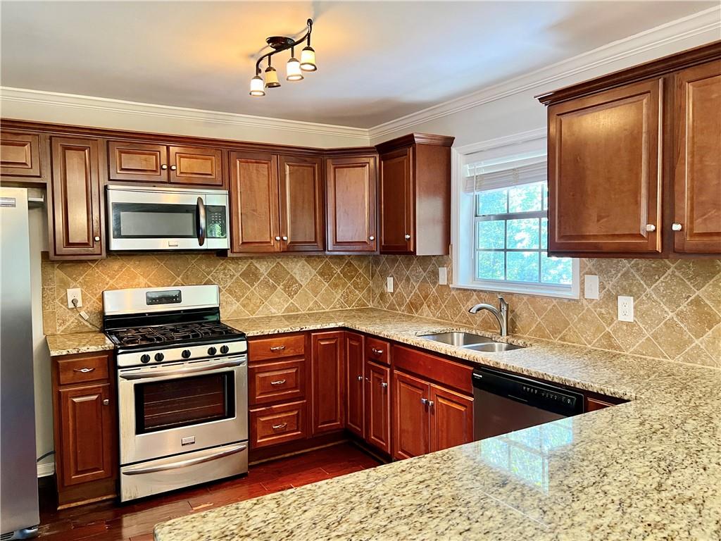 3211 Flamingo Drive East Point, GA 30344 - Photo 7 of 26 a kitchen with stainless steel appliances kitchen island granite countertop a sink stove and microwave