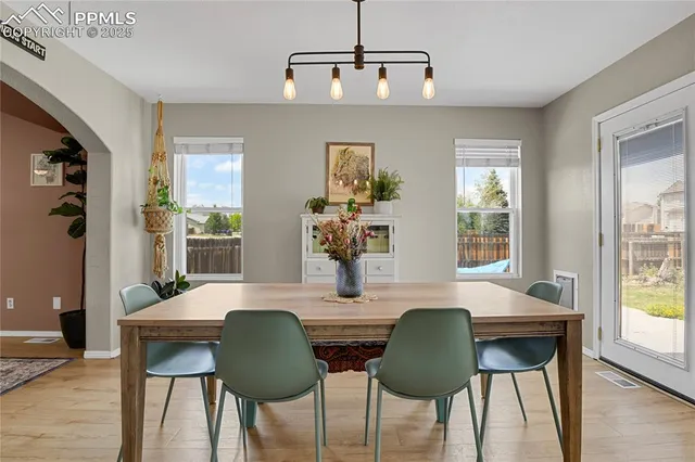 a view of a dining room with furniture and wooden floor
